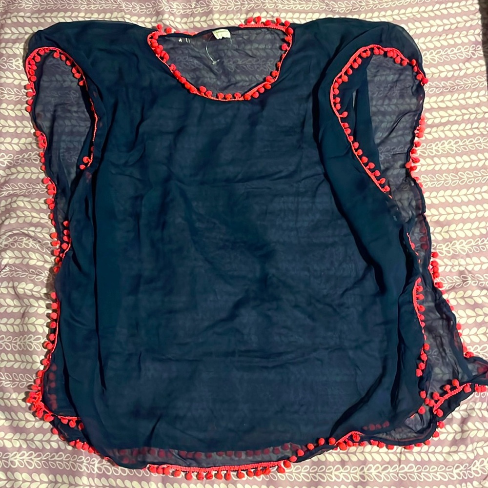 Large swimsuit cover. It’s navy blue with pink frills along the sides